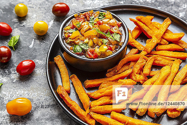 Homemade sweet potato fries and bowl of tomato basil dip
