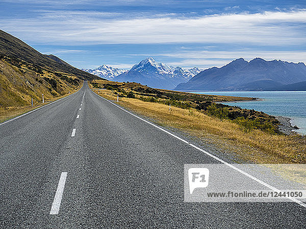 New Zealand  South Island  empty road with Aoraki Mount Cook and Lake Pukaki in the background