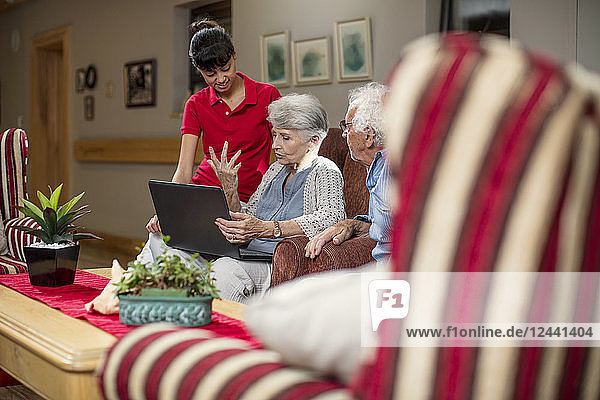 Seniors at retirement home looking at photo albums