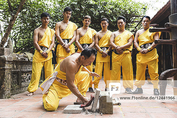 Vietnam  Hanoi  men exercising kung fu  man slabs flagstone