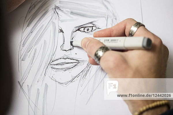 Close-up of artist drawing a sketch