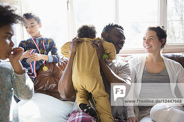 Happy multi-ethnic family on sofa