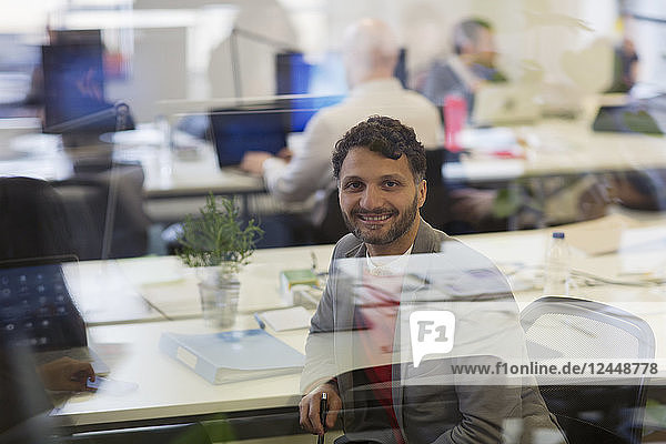 Portrait smiling  confident businessman working in office