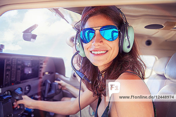 Portrait smiling  confident young woman flying airplane