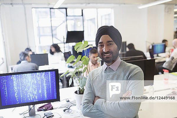 Portrait smiling  confident Indian computer programmer in turban in office