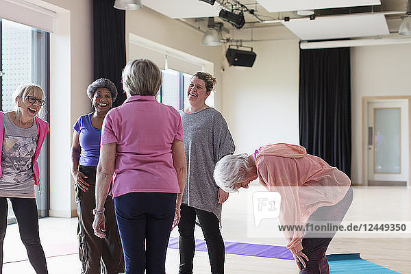 Active seniors talking after exercise class
