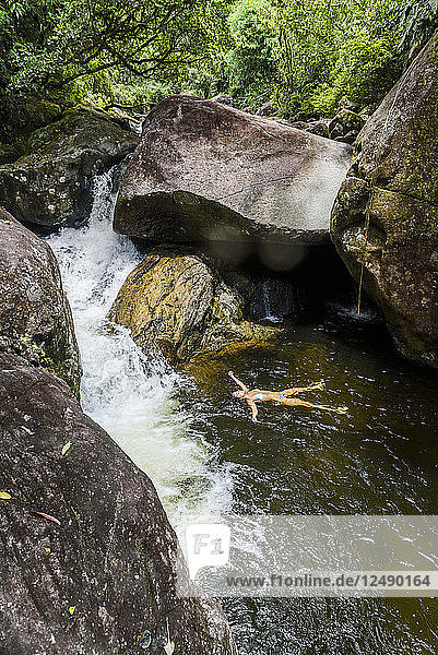 Woman bathing in Pirapetinga River in Serrinha do Alambari  Rio de Janeiro  Brazil
