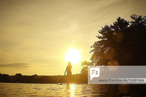 Silhouette Of A Woman On Stand-up Paddleboard On Upper Mystic Lake In Winchester