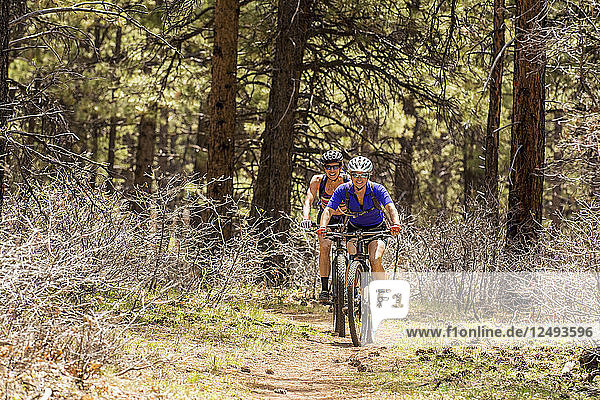 Two women mountain biking on the Boggy Draw Trail near Dolores  Colorado.
