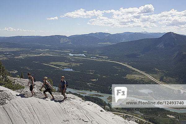 Elevated view of three hikers on ridgeline