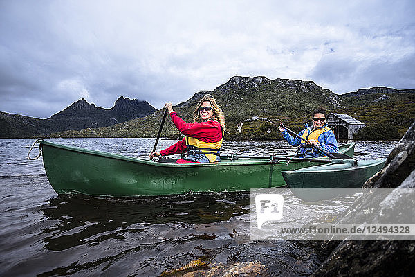 Canoeing around the famous boat shed on Dove Lake in Tasmania's Cradle Mountain  Lake St Clair National Park.
