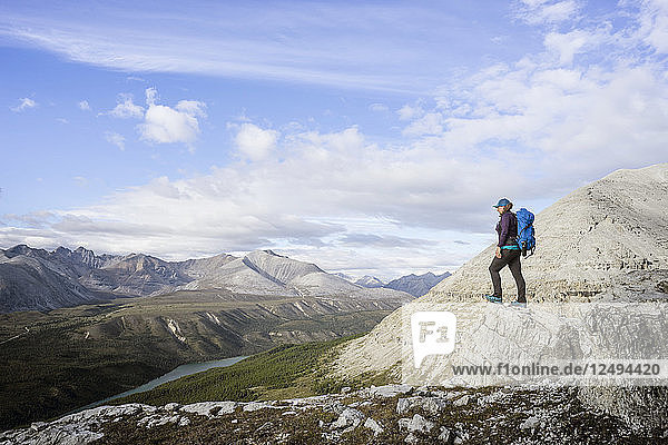 Female hiker at viewpoint on Stone Mountain British Columbia in the Northern Rockies