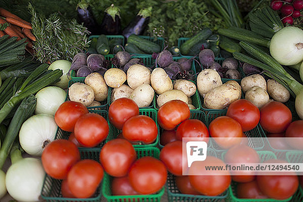 A mix of fresh vegetables for sale at a local farm market.