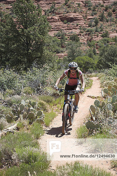 Woman rides the Submarine Rock Loop in South Sedona  Arizona. The trail has everything from slickrock to single track to stairs that lead to Submarine Rock.