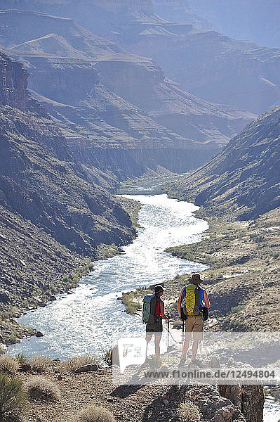Hikers overlook the Colorado River as they follow a route that connect Tapeats Creek and Thunder River to Deer Creek in the Grand Canyon outside of Fredonia  Arizona November 2011. The 21.4-mile loop starts at the Bill Hall trailhead on the North Rim and descends 2000-feet in 2.5-miles through Coconino Sandstone to the level Esplanada then descends further into the lower canyon through a break in the 400-foot-tall Redwall to access Surprise Valley. Hikers connect Thunder River and Tapeats Creek to a route along the Colorado River and climb out Deer Creek.
