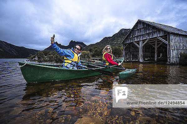 Canoeing around the famous boat shed on Dove Lake in Tasmania's Cradle Mountain  Lake St Clair National Park.