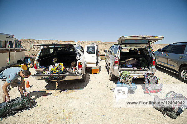 Hikers pack up their gear before hiking through the Grand Canyon.