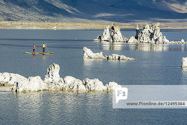 A woman and her daughter stand up paddleboarding on Mono Lake from South Tufa Beach  Lee Vining  California.