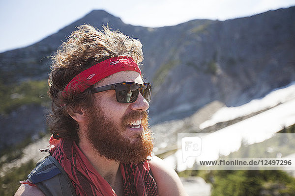 Portrait of Evan Howard  a climber and explorer  wearing a bandana and sporting a thick beard.