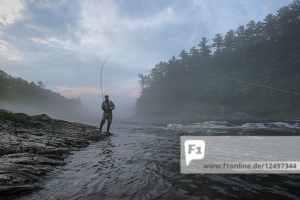 Fly Fisherman Fishing At Kennebec River Maine