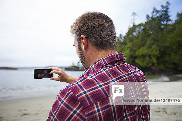 A Man Taking A Selfie At Half Moon Bay In Pacific Rim National Park  British Columbia