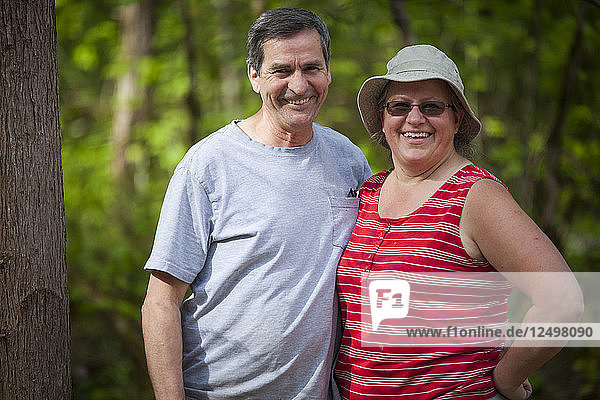Outdoor portrait of a middle-aged couple.