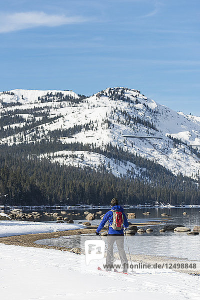 Woman skiing along shores of Donner Lake