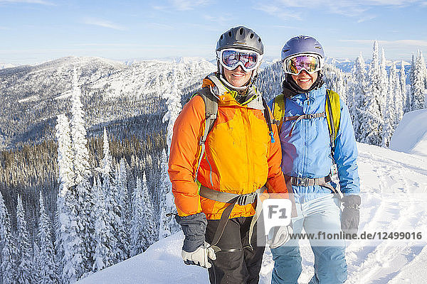 Two Female Backcountry Skiers On Snowy Landscape In Northwest Montana