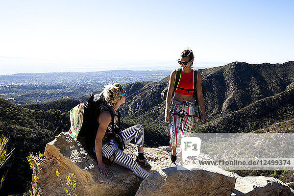 Two female climbers talk after climbing on Lower Gibraltar Rock in Santa Barbara  California.