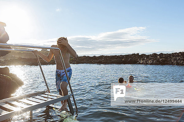 Father And Sons Enjoy The Natural Ocean Pools In Pico Island