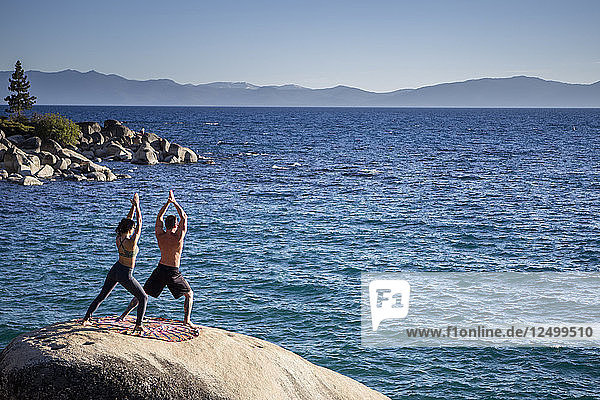 Man And Woman Practising Yoga At Lake Tahoe  Nevada  Usa