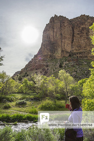 Woman Enjoying Coffee Near The Yampa River In Dinosaur National Monument  Utah  Usa