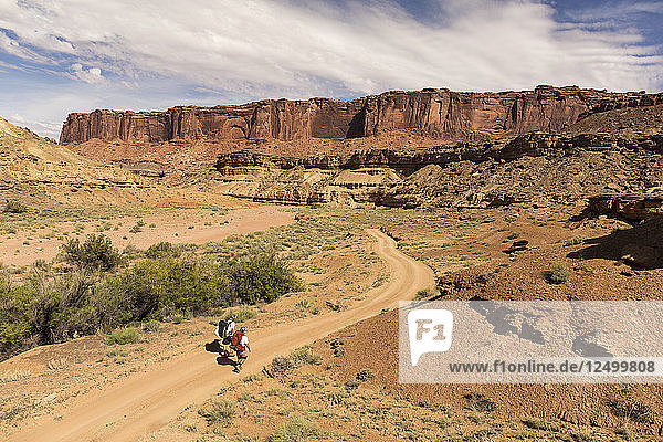 Two People Hiking In Canyonlands National Park