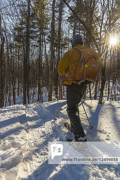 A Man Snowshoeing On Kennard Hill In Epping  New Hampshire