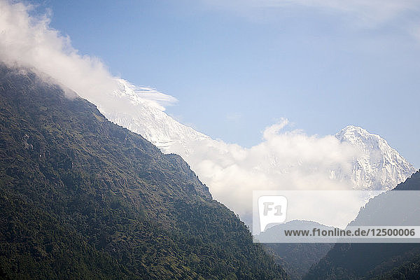 Die schneebedeckten Gipfel des Annapurna South vom Trekking-Rundweg in Nepal aus gesehen