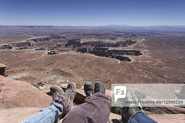 Hanging out feet over the Grand View in Canyonlands National Park.