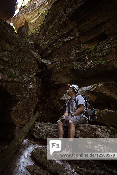 Man Exploring The Ellenville Fault Line Ice Caves In Ellenville  New York  Usa