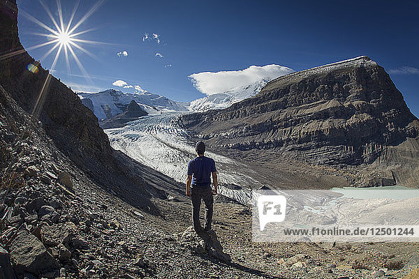 Rear View Of A Man Overlooking Glacier At Mount Robson Provincial Park  British Columbia  Canada