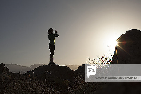 Silhouette der Frau beten in Alabama Hills National Recreation Area während des Sonnenaufgangs