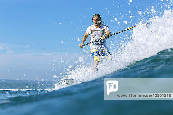 SUP surfer on a wave
