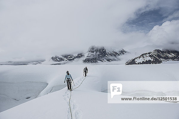 Zwei Bergsteiger beim Wandern in Gletscherspalten auf dem Ruth-Gletscher im Denali-Nationalpark