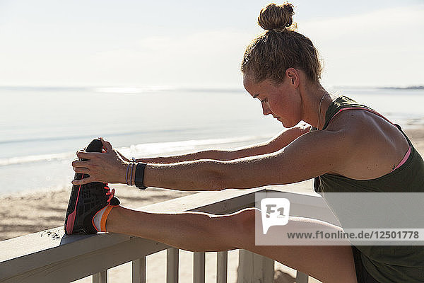 Woman Doing Stretching On Balcony Near Beach