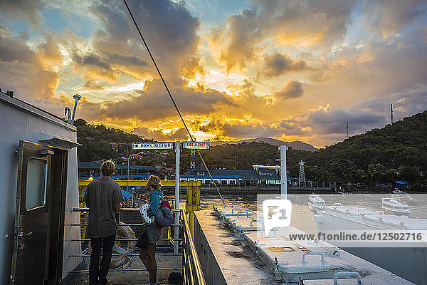 Ferry near Bali coast at sunset time.