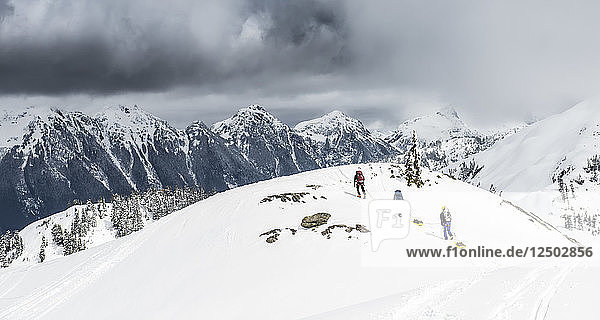 A group of climbers drag sleds of gear over the snow at Artist Poing in the Mount Baker Backcountry.