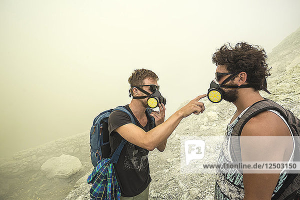 Two Male Hikers checking their air filters In Volcano Kawah Ijen  Java  Indonesia