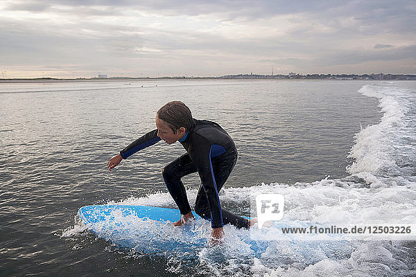 A Boy Surfs At Nahant Beach In Nahant  Massachusetts