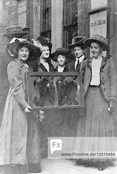 Fünf Suffragetten halten ein zerbrochenes Fenster in seinem Rahmen  1912. Künstler: Unbekannt
