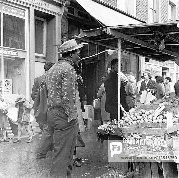 Afro-karibischer Mann auf einem Markt  London  ca. 1960-c1980. Künstler: Henry Grant