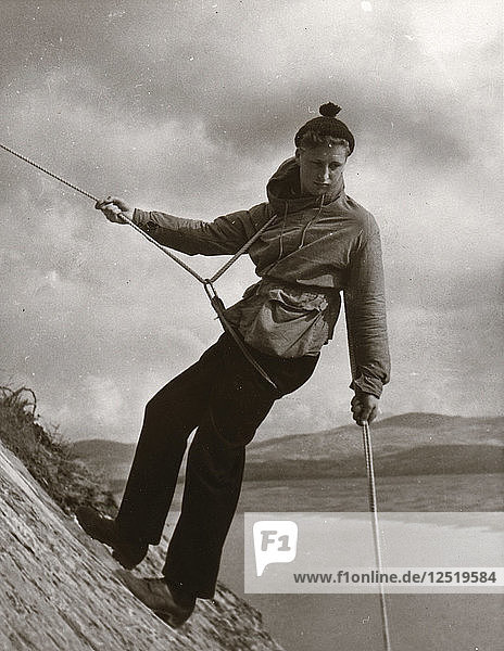 Boy descending rock face  Outward Bound School  Eskdale  Cumbria 1950. Artist: Unknown