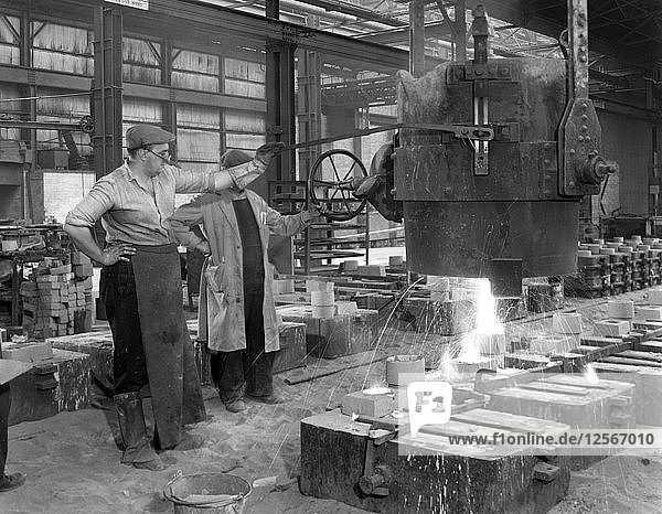 Pouring a small casting at Edgar Allens Steel foundry  Sheffield  South Yorkshire  1963. Artist: Michael Walters